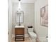 Modern half bathroom features a wood vanity, stylish mirror, and elegant light fixture at 8108 Farm Crossing Ln # 26, Huntersville, NC 28078