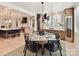 Open concept dining room leading into the kitchen, featuring light hardwood floors and modern lighting at 8108 Farm Crossing Ln # 26, Huntersville, NC 28078