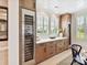 Dining area with custom built-in cabinetry, beverage refrigerator, and lots of natural light at 8108 Farm Crossing Ln # 26, Huntersville, NC 28078
