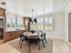 Elegant dining room with a round table, seating for six, large windows, and custom built-in cabinetry at 8108 Farm Crossing Ln # 26, Huntersville, NC 28078