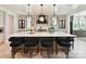 Kitchen island has bar stool seating and pendant lights, creating an elegant gathering space at 8108 Farm Crossing Ln # 26, Huntersville, NC 28078