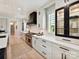 Gourmet kitchen featuring white cabinets, stainless steel appliances, a black range hood, and stylish black hardware at 8108 Farm Crossing Ln # 26, Huntersville, NC 28078