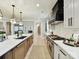 Gourmet kitchen with stainless steel appliances, a center island, and custom cabinetry at 8108 Farm Crossing Ln # 26, Huntersville, NC 28078