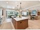 Bright open kitchen featuring a large island, pendant lighting, and seamless flow to the dining and living areas at 8108 Farm Crossing Ln # 26, Huntersville, NC 28078
