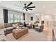 Cozy living room featuring a large ceiling fan, comfortable seating, and plenty of natural light at 8108 Farm Crossing Ln # 26, Huntersville, NC 28078