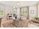 Stylish home office with natural light, plantation shutters, modern chandelier, neutral color palette, and area rug at 8108 Farm Crossing Ln # 26, Huntersville, NC 28078
