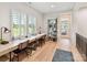Bright home office area featuring built-in desk, shelving, and large windows overlooking the lush outdoors at 8108 Farm Crossing Ln # 26, Huntersville, NC 28078