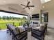 Cozy porch features fireplace, ceiling fan, and seating area with a view of the backyard at 8108 Farm Crossing Ln # 26, Huntersville, NC 28078