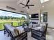 Covered outdoor living area complete with a fireplace, seating, and scenic views at 8108 Farm Crossing Ln # 26, Huntersville, NC 28078