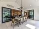 Covered porch with dining table and view of interior rooms through sliding glass doors at 8108 Farm Crossing Ln # 26, Huntersville, NC 28078