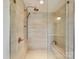 Luxurious walk-in shower with neutral tiling, rain shower head, and built-in bench at 8108 Farm Crossing Ln # 26, Huntersville, NC 28078