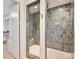 Modern walk-in shower with stylish tile, rainfall showerhead, and glass enclosure at 8108 Farm Crossing Ln # 26, Huntersville, NC 28078