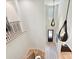 Open staircase with decorative railings, stylish pendant lighting, and a clear view of the front door at 8108 Farm Crossing Ln # 26, Huntersville, NC 28078