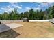 Large backyard featuring a small storage shed and white privacy fence at 8316 Highgate Dr, Charlotte, NC 28215
