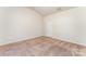 A cozy bedroom featuring plush carpeting and a neutral color scheme at 8316 Highgate Dr, Charlotte, NC 28215