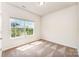 A light and airy bedroom with carpet and a large window to the outside at 8316 Highgate Dr, Charlotte, NC 28215