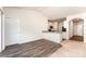 Open-concept living space featuring hardwood flooring and kitchen with white cabinets at 8316 Highgate Dr, Charlotte, NC 28215