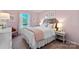 Charming bedroom with a pink accent wall, a queen-size bed, and soft, inviting decor at 833 Hallman Branch Ln, Lincolnton, NC 28092