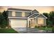 Beautiful two-story home featuring stone accents, a two-car garage, and manicured landscaping at 833 Hallman Branch Ln, Lincolnton, NC 28092