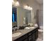 Bathroom featuring a double vanity, granite countertop, and updated fixtures at 10039 St Kitts Landing Ln, Charlotte, NC 28278