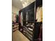 Organized walk-in closet with clothing racks, shelves, and storage drawers at 10039 St Kitts Landing Ln, Charlotte, NC 28278