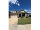 Charming home with stone accents, a two-car garage, and a well-manicured lawn on a sunny day at 10039 St Kitts Landing Ln, Charlotte, NC 28278
