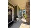 Inviting covered front porch with a decorative wreath, lantern, and seating area at 10039 St Kitts Landing Ln, Charlotte, NC 28278