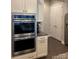 Gourmet kitchen with stainless steel double ovens, granite countertops, and custom cabinetry, perfect for culinary enthusiasts at 10039 St Kitts Landing Ln, Charlotte, NC 28278