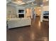 Open living room boasts a fireplace, coffered ceiling, and hardwood floors, flowing into the kitchen and dining area at 10039 St Kitts Landing Ln, Charlotte, NC 28278