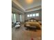 Spacious main bedroom with tray ceiling, sitting area, and natural light at 10039 St Kitts Landing Ln, Charlotte, NC 28278