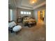 Spacious main bedroom with tray ceiling, sitting area, and ensuite bathroom at 10039 St Kitts Landing Ln, Charlotte, NC 28278