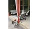 Cozy outdoor patio featuring a loveseat and chairs around a metal table, with an ornate privacy curtain at 10039 St Kitts Landing Ln, Charlotte, NC 28278