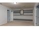 Spacious room with gray and white painted horizontal stripes, neutral carpet, and white doors at 109 Meadow Stream Dr, Mount Holly, NC 28120