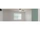 Cozy bedroom featuring a window with blinds and a ceiling fan, complemented by neutral-colored carpet at 109 Meadow Stream Dr, Mount Holly, NC 28120