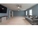 Upstairs bonus room with ample space, carpeted floors, ceiling fans, and a TV at 109 Meadow Stream Dr, Mount Holly, NC 28120
