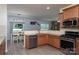 Bright kitchen includes stainless steel appliances, granite countertops, and wood-look flooring at 109 Meadow Stream Dr, Mount Holly, NC 28120