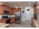 Well-lit kitchen features stainless steel appliances, wood cabinets, and granite countertops at 109 Meadow Stream Dr, Mount Holly, NC 28120