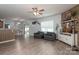 Open-concept living area with wood-look floors, ceiling fan, and cozy seating at 109 Meadow Stream Dr, Mount Holly, NC 28120