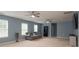 Spacious living room with two ceiling fans, neutral carpet, and lots of natural light at 109 Meadow Stream Dr, Mount Holly, NC 28120