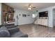 Spacious living room features wood-look floors, a ceiling fan, and rustic wood accents at 109 Meadow Stream Dr, Mount Holly, NC 28120