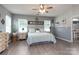 Comfortable bedroom boasts wood-look floors, dual windows, and ceiling fan at 109 Meadow Stream Dr, Mount Holly, NC 28120