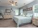Tranquil main bedroom with wood-look floors, ample natural light, and stylish decor at 109 Meadow Stream Dr, Mount Holly, NC 28120