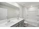 Well-lit bathroom featuring double sinks, a large mirror, and a shower-tub combo at 110 Obadiah Ct, Mooresville, NC 28115