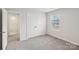 A cozy bedroom with double door closet, neutral paint, carpet flooring, and a bright window at 110 Obadiah Ct, Mooresville, NC 28115