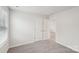 A simple bedroom featuring carpeted floors, a double door closet, and natural light at 110 Obadiah Ct, Mooresville, NC 28115