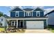 Beautiful, two-story home with a blue exterior, white trim, and a spacious two-car garage in a residential neighborhood at 110 Obadiah Ct, Mooresville, NC 28115