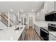 Open kitchen with gray cabinets, stainless steel appliances and quartz countertops at 110 Obadiah Ct, Mooresville, NC 28115