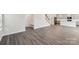 Open-concept living space with wood-look flooring, stairs and access to the kitchen at 110 Obadiah Ct, Mooresville, NC 28115