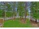 Scenic view from the deck overlooking the spacious backyard, trees and the lake at 112 Nautilus Ct, Troutman, NC 28166
