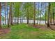 Expansive backyard featuring mature trees and a waterfront view at 112 Nautilus Ct, Troutman, NC 28166